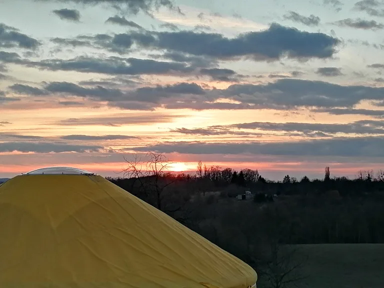Barna's own yurt in sunset silhouette, in an off-grid landscape